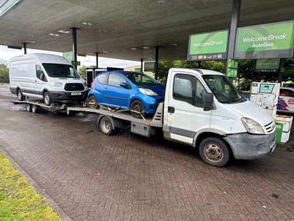 Roadsist Auto transporter carrying a car and towing a van on a trailer at motorway services near Glasgow